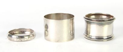 THREE SILVER NAPKIN RINGS, the larger two engraved with names and the smaller initialled and