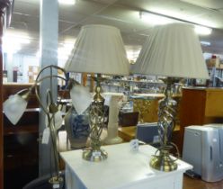 A BRASS THREE LIGHT STANDARD LAMP AND TWO SIMILAR TABLE LAMPS (3)