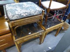 TWO BAMBOO SQUARE COFFEE TABLES, WITH GLASS TOPS AND A STOOL, OBLONG WITH LOOSE CUSHION