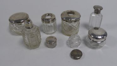 COLLECTION OF SEVEN GLASS DRESSING TABKLE JARS AND BOTTLES WITH SILVER COVERS, 2.05ozt of