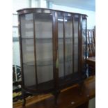 A MID-CENTURY WALNUT WOOD BOW FRONTED DISPLAY CABINET