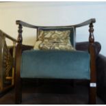 A MAHOGANY FRAMED LOW SEATED TUB CHAIR, COVERED IN GREEN FABRIC