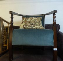 A MAHOGANY FRAMED LOW SEATED TUB CHAIR, COVERED IN GREEN FABRIC