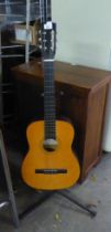 A HOHNER MC-03 ACOUSTIC GUITAR ON STAND