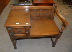 JACOBEAN STYLE CARVED OAK TELEPHONE TABLE, WITH PANELLED BACK, SMALL CUPBOARD ON BALUSTER LEGS