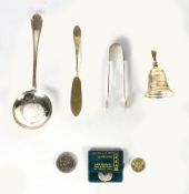 SMALL ELECTRO-PLATED TABLE BELL, a plated serving spoon, pair of sugar tongs, a butter knife, a