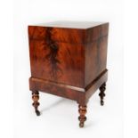 WILLIAM IV FLAME CUT MAHOGANY CELLARETTE, of square form, the hinged top enclosing nine divisions to