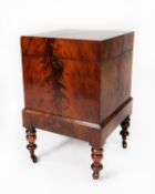 WILLIAM IV FLAME CUT MAHOGANY CELLARETTE, of square form, the hinged top enclosing nine divisions to