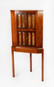 EARLY TWENTIETH CENTURY FIGURED WALNUT CORNER CABINET ON STAND, the upper section with two pairs