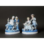 PAIR OF EARLY TWENTIETH CENTURY KPM STYLE PORCELAIN GROUPS, each heightened in blue and modelled