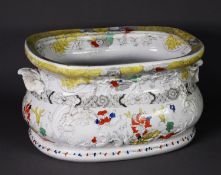 NINETEENTH CENTURY MOULDED POTTERY TWO HANDLED FOOTBATH, of rounded oblong, bellied form, floral