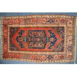 LARGE EASTERN RUG, with red plain field mostly filled by the large rectangular centre midnight