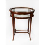 EDWARDIAN STYLE LINE INLAID MAHOGANY BIJOUTERIE DISPLAY TABLE WITH GILT METAL MOUNTS, of oval form