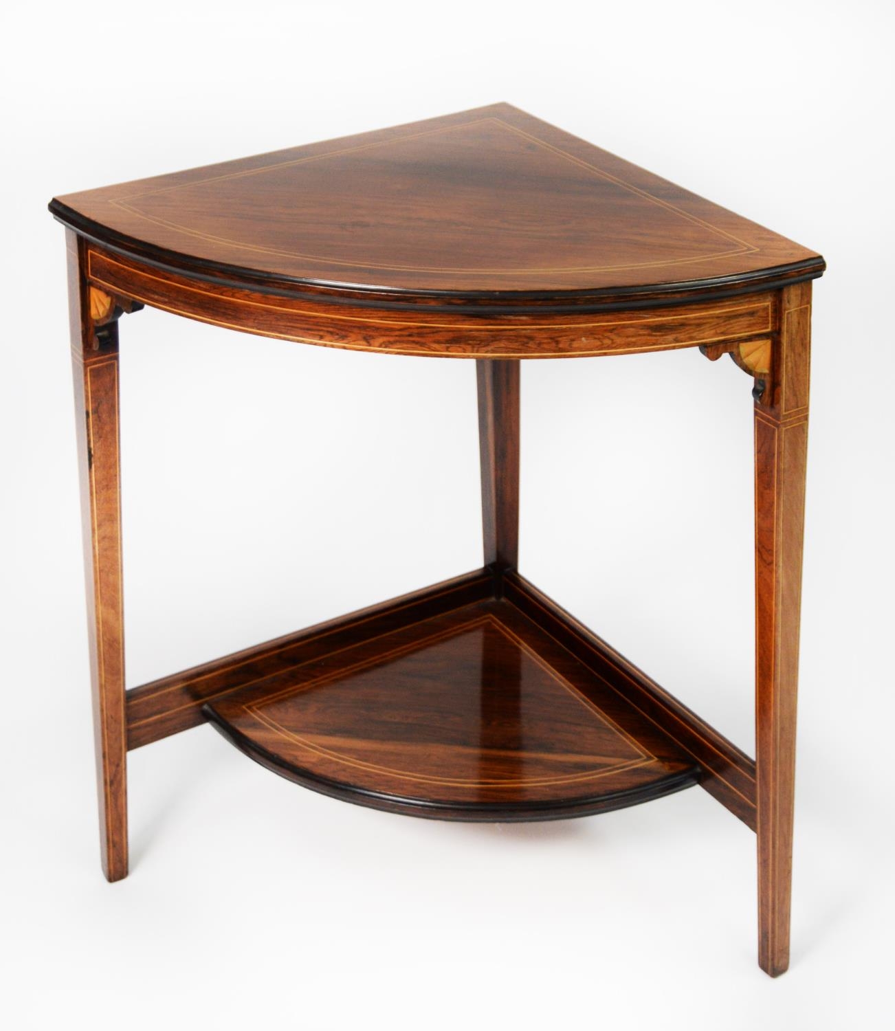 AN EDWARDIAN LINE INLAID ROSEWOOD CORNER TABLE, with under-shelf, on three square tapering legs, 2'