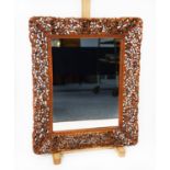 MODERN ANGLO PERSIAN CARVED AND PIERCED BLONDE WOOD WALL MIRROR, the oblong plate within a chamfered