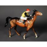 BESWICK GLAZED CHINA BAY RACEHORSE with jockey up, in walking pose, 8 1/2in (21.5cm) high