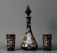 EARLY TWENTIETH CENTURY MOSER STYLE ENAMELLED AMETHYST GLASS DECANTER AND MATCHING PAIR OF
