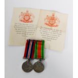 TWO WORLD WAR II MEDALS WITH RIBBONS, sewn onto a bar brooch, 1939 - 1945 The Defence Medal and