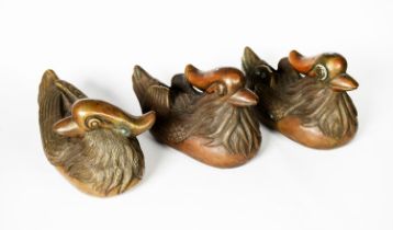 THREE CHINESE PATINATED COPPER ALLOY MODELS OF MANDARIN DUCKS, each bearing an embossed six