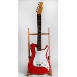 FENDER BULLET STYLE SIX STRING ELECTRIC GUITAR, in red, bears green sticky label to the back of