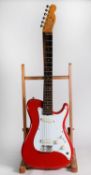 FENDER BULLET STYLE SIX STRING ELECTRIC GUITAR, in red, bears green sticky label to the back of