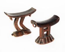 TWO AFRICAN CARVED WOODEN PILLOWS OR HEAD RESTS, 7 1/2in (19cm) and 6 1/2in (16.5cm) long