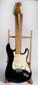 FENDER STRATOCASTER STYLE SIX STRING ELECTRIC GUITAR, in black, bears oblong white metal label to
