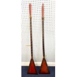 PAIR OF POSSIBLY SOUTH EAST ASIAN LACQUERED WOODEN PADDLES, the blades of triangular form with