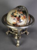 HARDSTONE INSET TERRESTRIAL GLOBE, 9in (23cm) diameter, on heavy brass table top stand with three