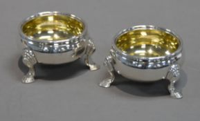 PAIR OF EARLY VICTORIAN SILVER SALT CELLARS with gilded interiors, each on three stepped pad feet,