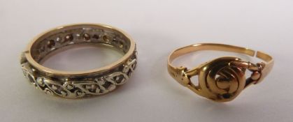 WHITE STONE ETERNITY RING, marked ‘9CT’, ring size J1/2; and a FLORAL RING, unmarked (cut), 4.6g