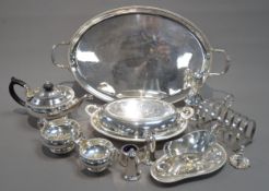 OVAL ELECTRO-PLATED TWO HANDLED TEA TRAY, A PLATED THREE PIECE TEA SERVICE, A GRAVY BOAT ON STAND, A
