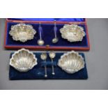 CASED PAIR OF LATE VICTORIAN STAMPED SILVER SALT-CELLARS with associated spoons, Birmingham 1897.
