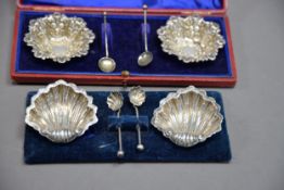 CASED PAIR OF LATE VICTORIAN STAMPED SILVER SALT-CELLARS with associated spoons, Birmingham 1897.