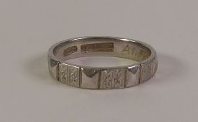 PLATINUM BAND RING, of angular form with foliate and angular decoration, marked 'PLAT', with