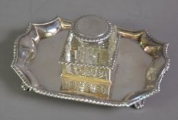 EDWARD VII SILVER AND CUT GLASS INKSTAND BY JAMES DIXON & SONS, of shaped oblong form with gadrooned