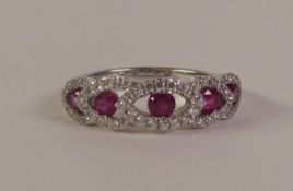 18CT WHITE GOLD RUBY AND DIAMOND RING, five round-cut rubies within diamond set lozenge frames,