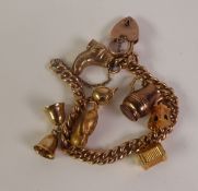 A 9CT GOLD CURB LINK CHARM BRACELET, with seven 9ct gold charms and a 9ct gold padlock clasp, 18cm