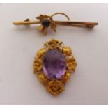 VICTORIAN AMETHYST BROOCH, an oval amethyst within a fancy shell and cannetille frame, 2.2cm by 3.