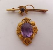 VICTORIAN AMETHYST BROOCH, an oval amethyst within a fancy shell and cannetille frame, 2.2cm by 3.