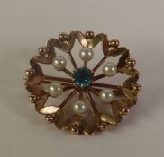 9ct GOLD CIRCULAR OPENWORK BROOCH, set with a CENTRAL BLUE STONE and SIX SEED PEARLS, 6.5gms gross