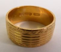 22CT GOLD BAND RING, with laurel and geometric decoration, London 1962, ring size H1/2, 5.3g
