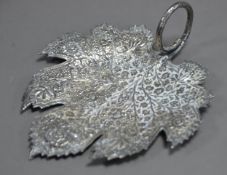 FOREIGN, UNMARKED SILVER COLOURED METAL LEAF SHAPED DISH, profusely embossed with flowering leafy