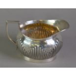 LATE VICTORIAN SILVER MILK JUG BY MAPPIN & WEBB, of oval part fluted form with angular scroll handle