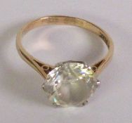 A WHITE ZIRCON SOLITAIRE RING, a round brilliant-cut white zircon in a claw setting, to a plain