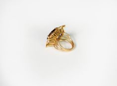 GOLD COLOURED METAL DRESS RING, set with a square tiger's eye stone, in a four claw setting with a