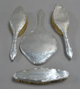 INTER-WAR YEARS SILVER-BACKED FOUR PIECE LADY'S DRESSING TABLE BRUSH SET including hand mirror,