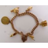 9CT GOLD CURB LINK CHARM BRACELET, with a 9ct gold padlock clasp and suspending five charms (one 9ct