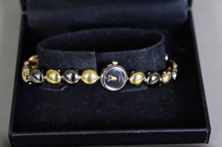 LADY'S ACCURIST GOLD PLATED BRACELET WATCH, with quartz movement, circular dial and bi-colour beaded