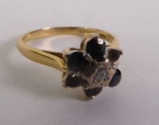 18CT GOLD SAPPHIRE AND DIAMOND CLUSTER RING, a round brilliant-cut diamond within a sapphire border,